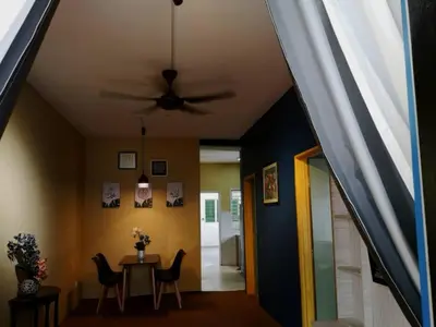 a dining room with a ceiling fan and a table at Barakah Sufi Home Stay Apartment Cameron in Tanah Rata