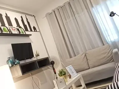 a living room with a couch and a television at Barakah Sufi Home Stay Apartment Cameron in Tanah Rata
