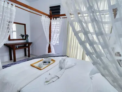 a bedroom with a bed with a tray on it at IPOH Chemor Casa Klebang, 5 PAX Fully Air-Con Homestay in Chemor