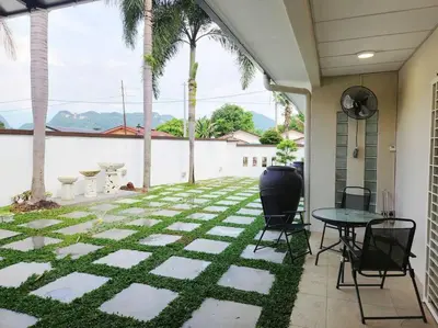 a patio with a table and chairs on a patio at Tambun lost world luxury villa 5BR/20 pax/mahjong/karaok/bbq/garden events in Tambun