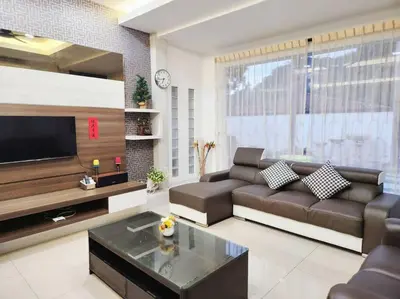 a living room with a couch and a flat screen tv at Tambun lost world luxury villa 5BR/20 pax/mahjong/karaok/bbq/garden events in Tambun