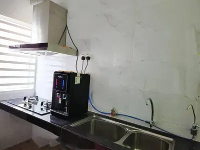 a kitchen with a sink and a coffee maker on a counter at IPOH BOTANI bauhaus 17pax/4BR/mahjong/tv box in Ipoh