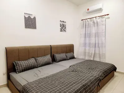a bed with two pillows on it in a room at IPOH BOTANI bauhaus 17pax/4BR/mahjong/tv box in Ipoh