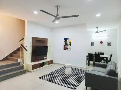 a living room with a couch and a flat screen tv at IPOH BOTANI bauhaus 17pax/4BR/mahjong/tv box in Ipoh