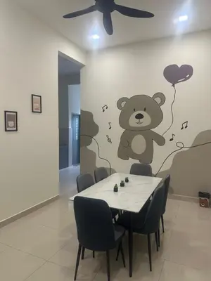 a dining room with a table with a teddy bear on the wall at Pantai Remis Bear Homestay in Pantai Remis