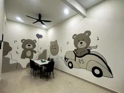 a dining room with teddy bears and a car on the wall at Pantai Remis Bear Homestay in Pantai Remis