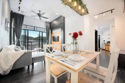 a dining room and living room with a table and chairs at Serene Nova Family Retreat (2-6pax)near Kea Farm Market in Brinchang