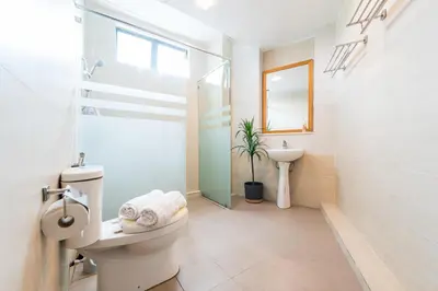 a white bathroom with a toilet and a sink at Serene Nova Family Retreat (2-6pax)near Kea Farm Market in Brinchang