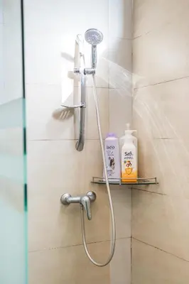 a shower with a shower head in a bathroom at Serene Nova Family Retreat (2-6pax)near Kea Farm Market in Brinchang
