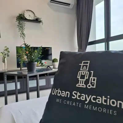 a pillow on a bed in a room with a desk at New Urban Suite Majestics 3BR Homestay at Georgetown BY URBAN STAYCATION LOD PULSE in Jelutong