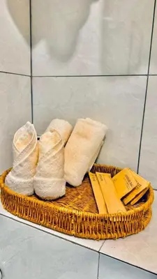 a wicker basket with towels and socks on the floor at The Leith in George Town