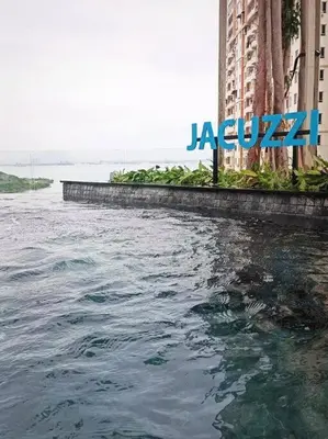 a large body of water next to a large building at Romantic Sea View @ Urban Suite in Jelutong