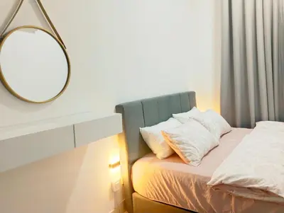a bedroom with a bed with a mirror on the wall at UR Homestay, Seri Iskandar in Seri Iskandar