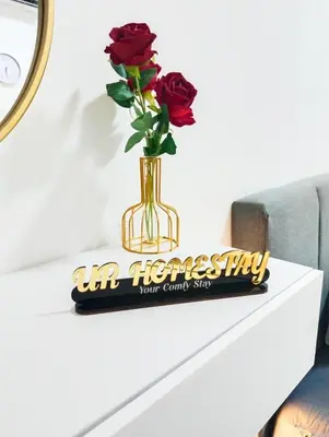 a vase with roses sitting on a table at UR Homestay, Seri Iskandar in Seri Iskandar