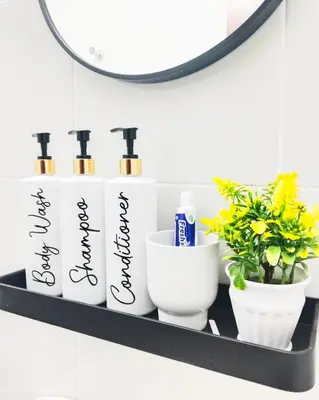 a shelf with four bottles ofodorizers and a mirror at UR Homestay, Seri Iskandar in Seri Iskandar