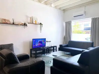 a living room with couches and a flat screen tv at Modern Cozy House 4 ROOM 10pax@Bukit Mertajam in Bukit Mertajam