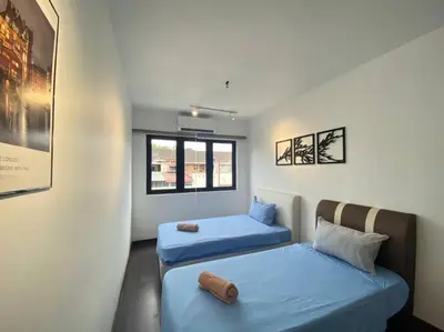 a room with two beds and a window at Modern Cozy House 4 ROOM 10pax@Bukit Mertajam in Bukit Mertajam