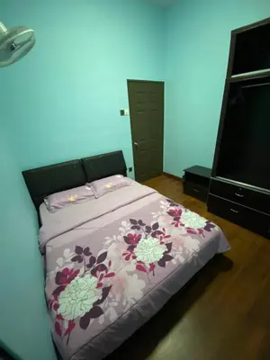 a bedroom with a bed and a flat screen tv at Frosty Hills Homestay in Tanah Rata