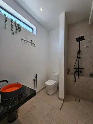a bathroom with a toilet and a shower and a sink at Ipoh Young Villa - Hotel Inspired in Ipoh