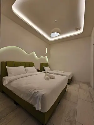 two beds in a hotel room with at Ipoh Young Villa - Hotel Inspired in Ipoh