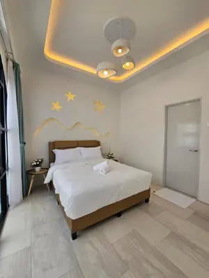 a bedroom with a bed with stars on the ceiling at Ipoh Young Villa - Hotel Inspired in Ipoh