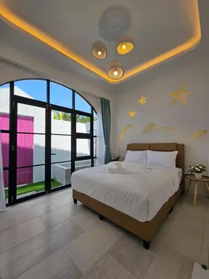 a bedroom with a bed with stars on the ceiling at Ipoh Young Villa - Hotel Inspired in Ipoh