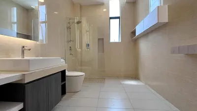 a bathroom with a sink and a shower and a toilet at Grand’e La Villa Homestay in Lumut