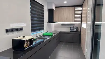 a kitchen with a sink and a toaster on a counter at Grand’e La Villa Homestay in Lumut