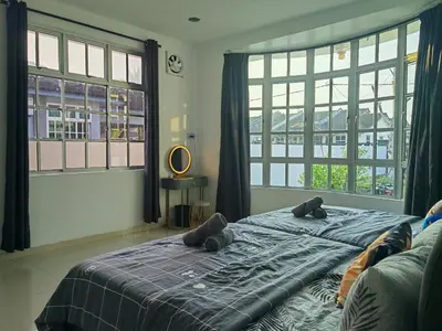 a bedroom with a bed with two teddy bears on it at Cozy Roomstay Padang Serai in Padang Serai