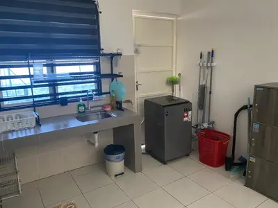 a kitchen with a sink and a refrigerator at Abu Fateh Homestay in Seri Iskandar