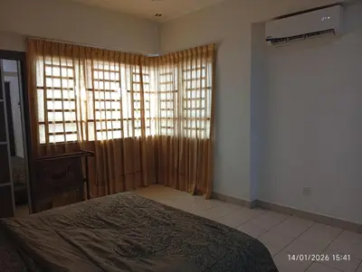 a bedroom with a bed and a window with curtains at Seberang Jaya Family Pool Homestay Near Hospital 3 Bedroom Aircond 2 Bathroom & Family Room Aircond in Perai