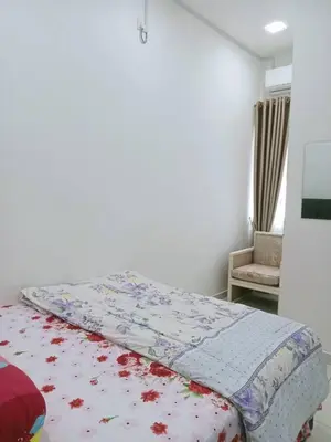a bed with a quilt on it in a bedroom at MR OT HOMESTAY ( BAITUL RAUDHAH ) in Kepala Batas