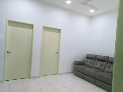 a living room with a couch and two doors at MR OT HOMESTAY ( BAITUL RAUDHAH ) in Kepala Batas