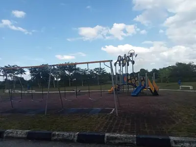 a playground with a swing set in a park at MR OT HOMESTAY ( BAITUL RAUDHAH ) in Kepala Batas