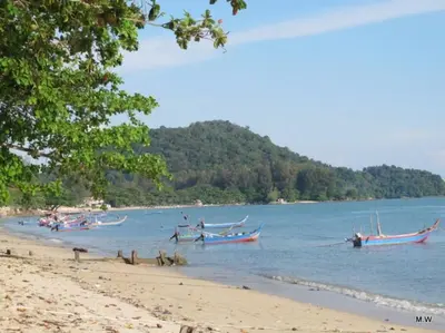 a group of boats in the water on a beach at Cosy HomeStay at Penang Island -Beach and Village in Bayan Lepas
