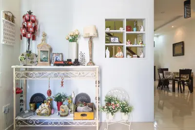 a shelf with christmas items on it in a room at Cosy HomeStay at Penang Island -Beach and Village in Bayan Lepas