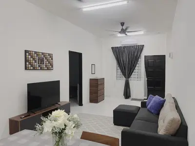 a living room with a couch and a tv at MamaShy Homestay Manjung -FREE WIFI- in Seri Manjung