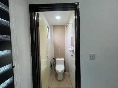 a small bathroom with a toilet and a shower at MamaShy Homestay Manjung -FREE WIFI- in Seri Manjung