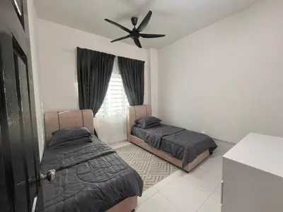 a bedroom with two beds and a ceiling fan at MamaShy Homestay Manjung -FREE WIFI- in Seri Manjung