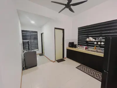 a living room with a ceiling fan and a kitchen at MamaShy Homestay Manjung -FREE WIFI- in Seri Manjung
