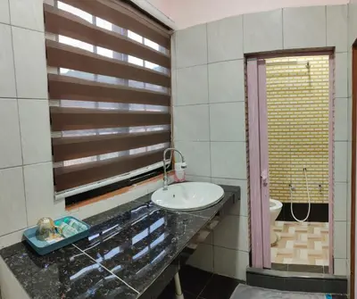 a bathroom with a sink and a mirror at Santai Desa Chalet musleem 0nly in Brinchang