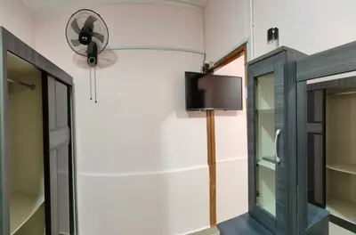 a room with a fan and a window at Santai Desa Chalet musleem 0nly in Brinchang