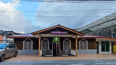 a building with a car parked in front of it at Santai Desa Chalet musleem 0nly in Brinchang