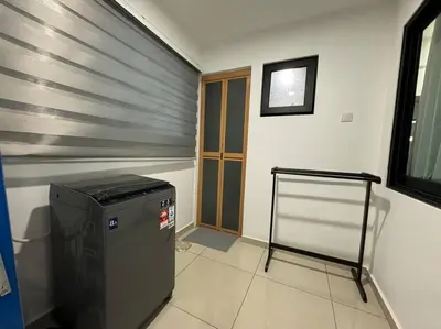 a laundry room with a machine in the corner of a room at 【NEW】Harmony’s Home@Juru Sentral Icon City in Bukit Mertajam