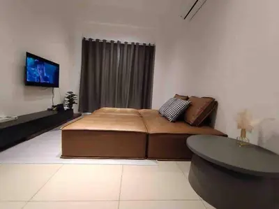 a bedroom with a large bed and a flat screen tv at be.Paradise Duplex@The Cove-8mins to LWOT-12-14pax in Ipoh