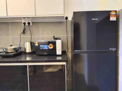 a kitchen with a black refrigerator and a toaster at be.Paradise Duplex@The Cove-8mins to LWOT-12-14pax in Ipoh