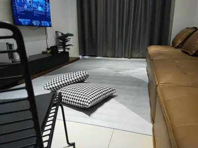 a living room with a couch and a chair at be.Paradise Duplex@The Cove-8mins to LWOT-12-14pax in Ipoh
