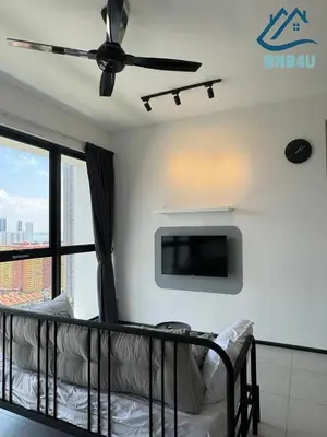 a bedroom with a bed and a flat screen tv at Urban Suites @ George Town Penang by BNB4U in George Town