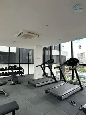 a gym with several tread machines in a room with windows at Urban Suites @ George Town Penang by BNB4U in George Town