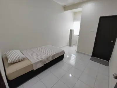 a bedroom with a bed in a white room at Homestay in manjung pr1ma segari-Melayu only in Lumut